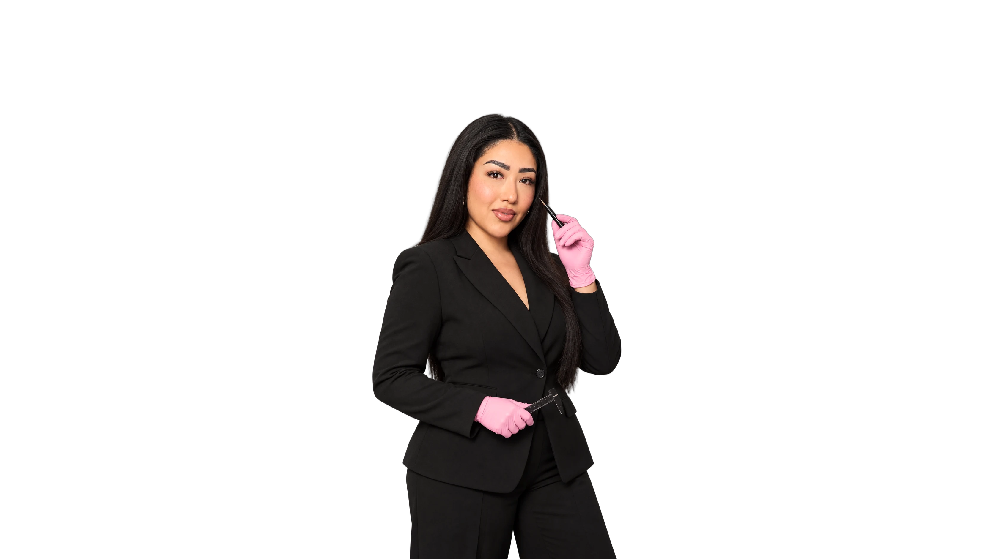 Isis Coheto, founder of IC Brow Studio, holding a microblading pen